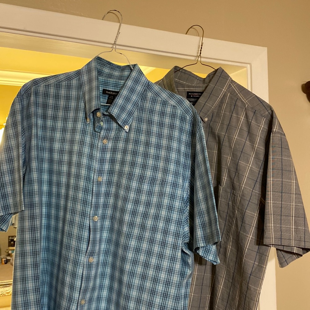 Two men’s short sleeve button up dress shirts with the left breast pocket